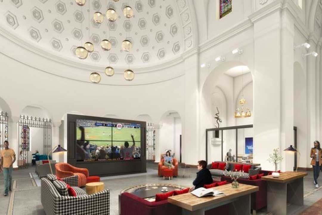 Lounge space with a huge flat screen TV and comfortable couches and seats.