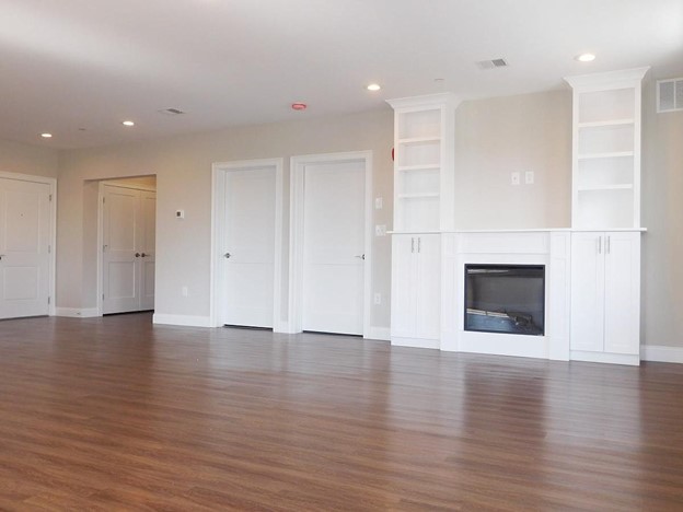 wide open, built-in fire place with mantle and shelving. Recessed lighting.