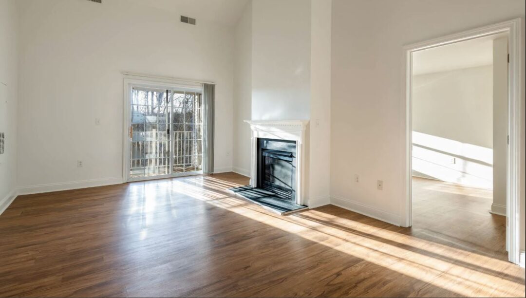 open concept living room with hardwood floors, natural light and balcony