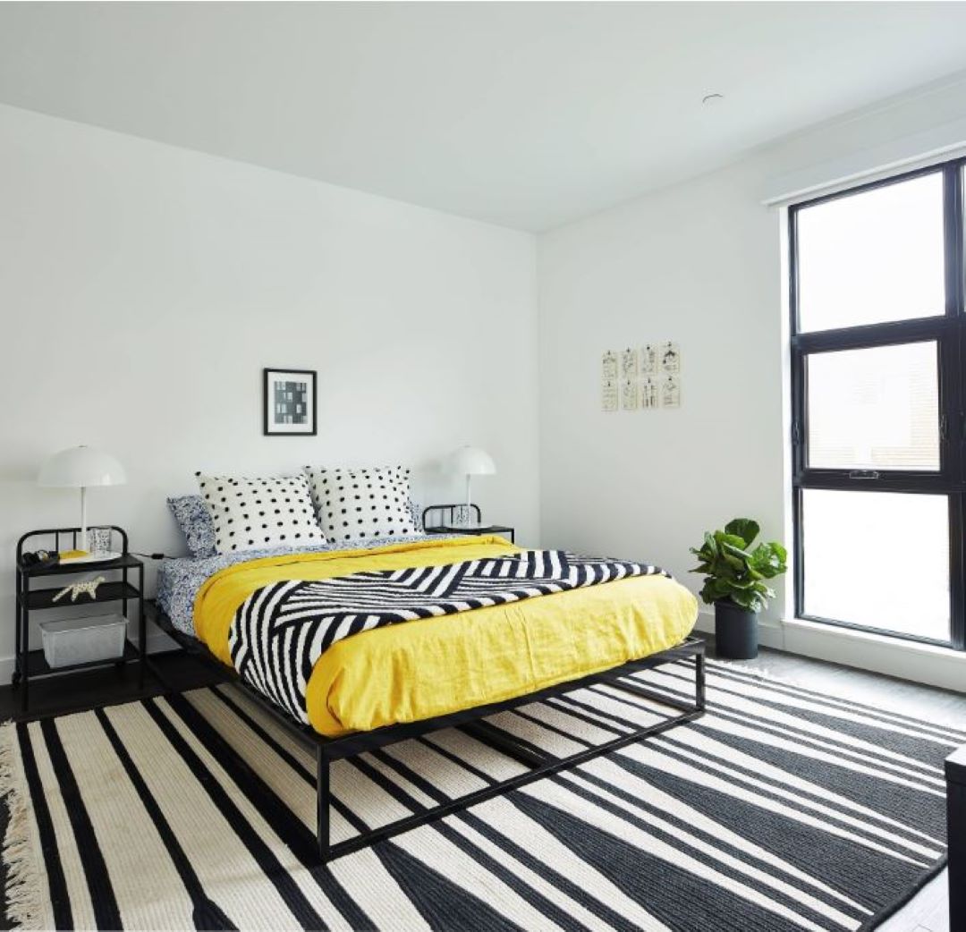 small white bedroom with picture window and natural light