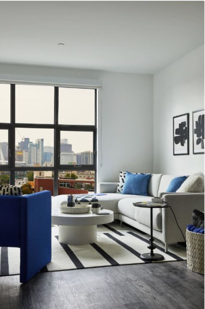 modern living area with white walls, picture window and natural light