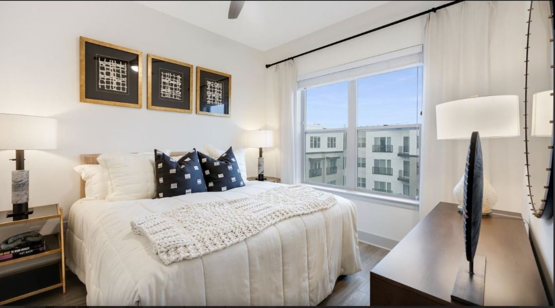 small white bedroom with large picture window