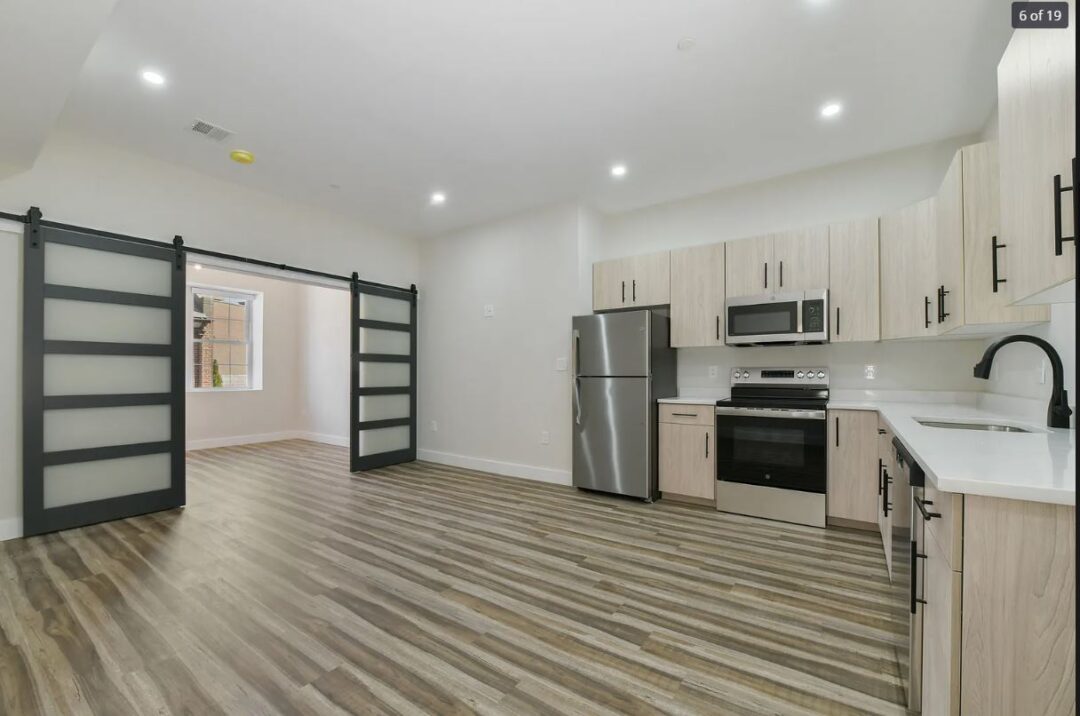 updated kitchen with light cabinets stainless steel appliances and wood floors