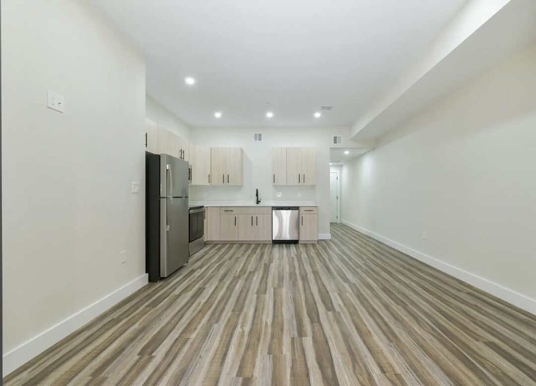 updated kitchen with light cabinets stainless steel appliances and wood floors