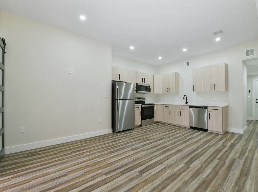 updated kitchen with light cabinets stainless steel appliances and wood floors