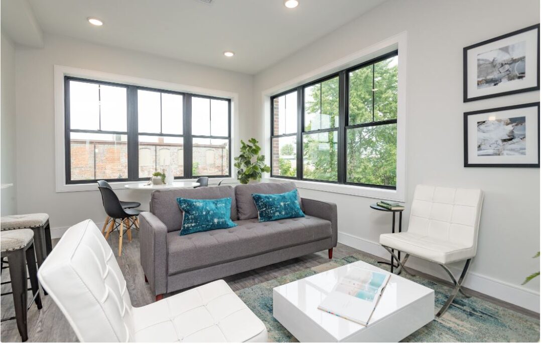 modern living room with wood floors and dual picture windows for lighting