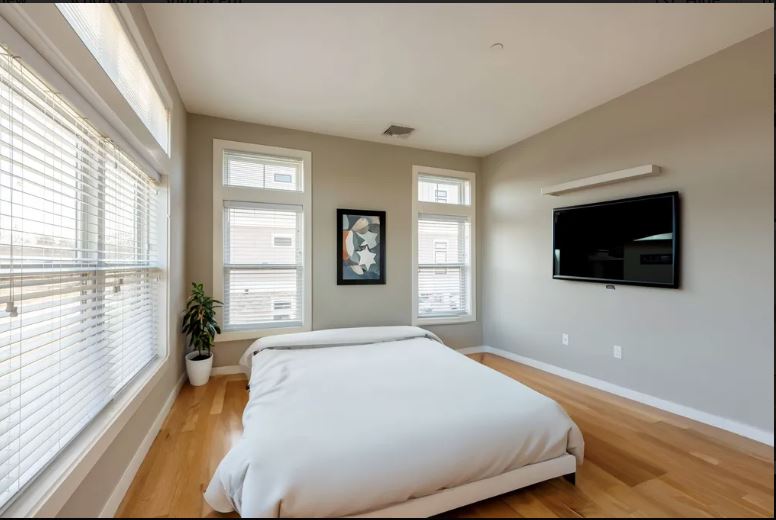598 - 600 North St. bedroom with beige walls, wood floors and natural light