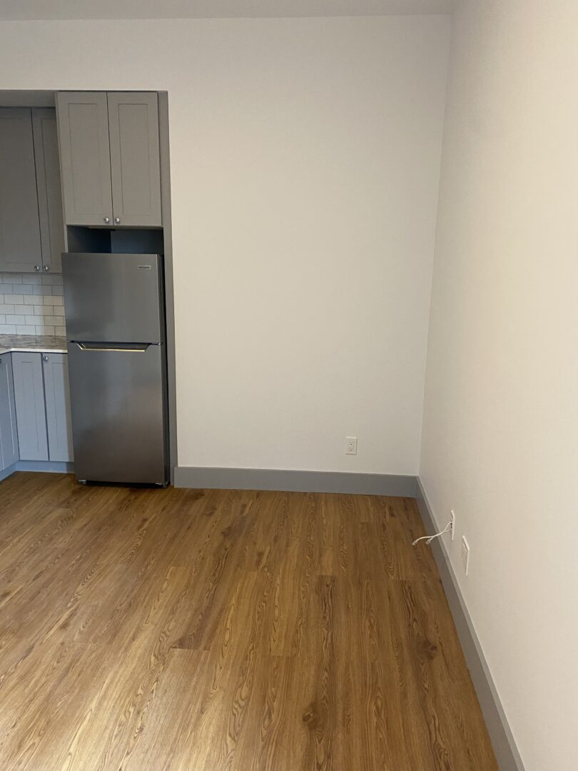 room with white walls and wood floors