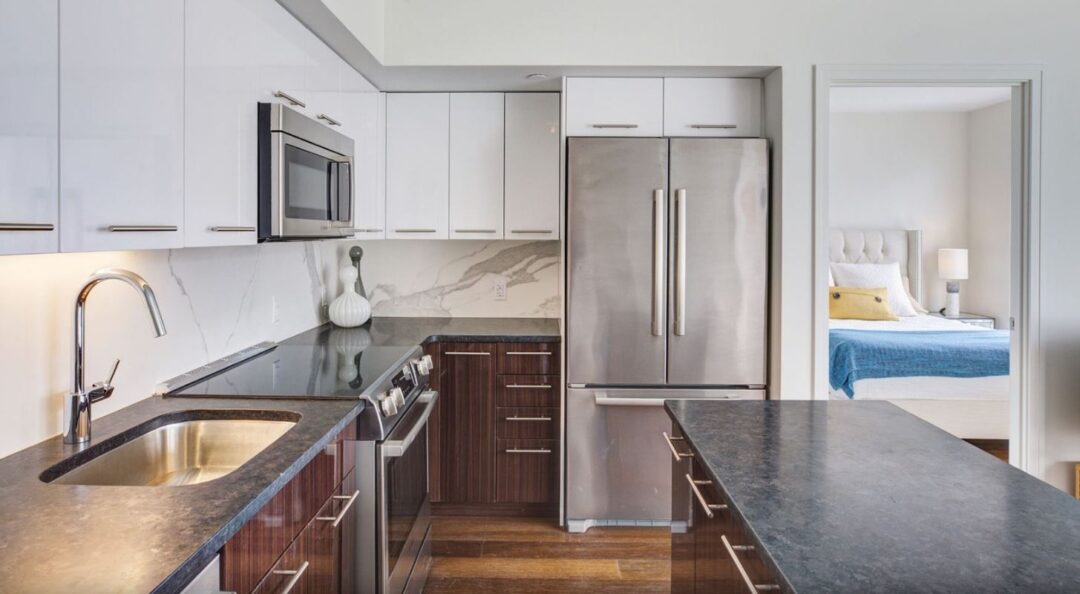 Updated kitchen with wood floors and stainless steel appliances