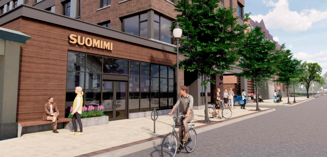 storefront building with sidewalks and people walking/biking
