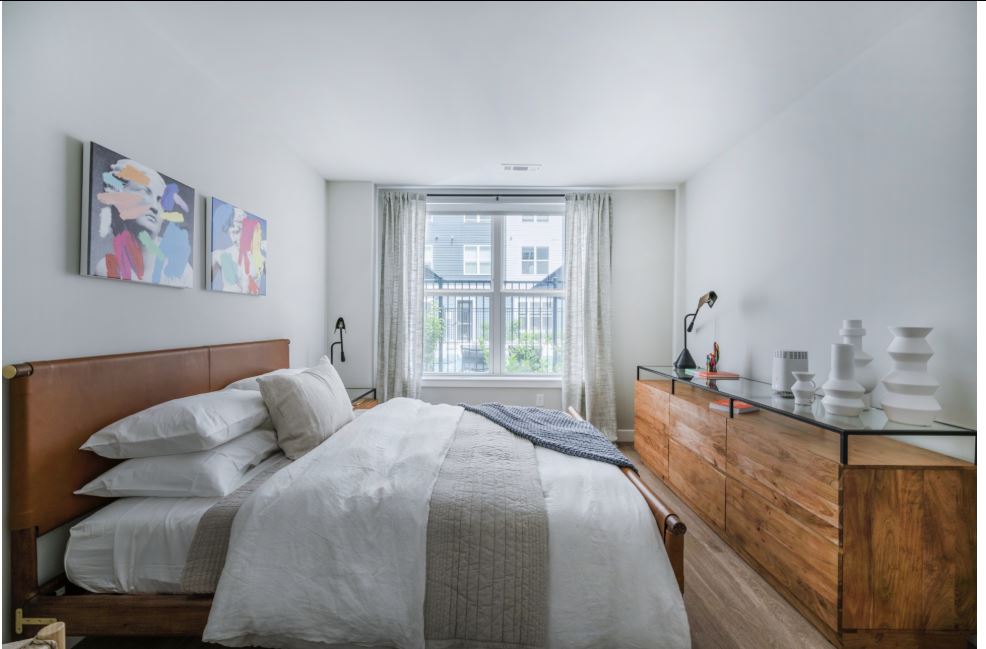 small white bedroom with natural light and white walls