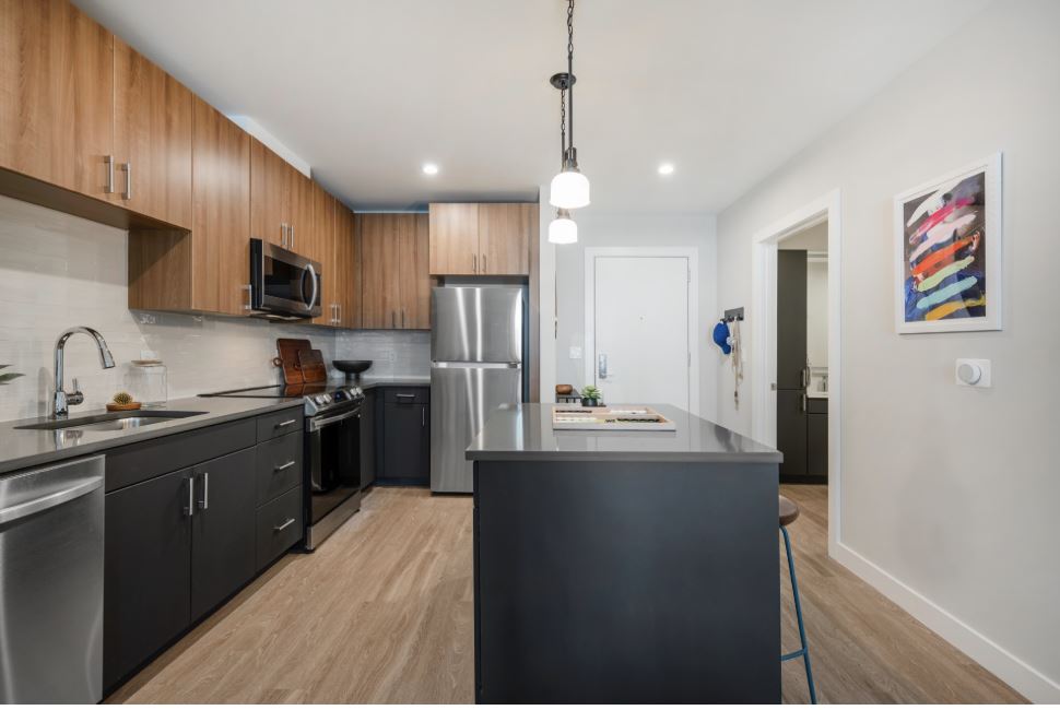 Modern kitchen with stainless steel appliances and wood floors