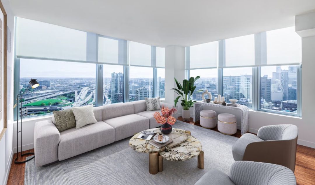 open concept living room with lots of windows and natural light, couches, and coffee table
