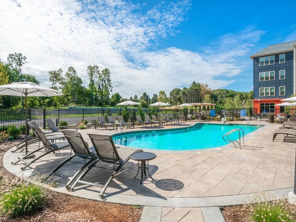1. Outdoor swimming pool with poolside lounge chairs.